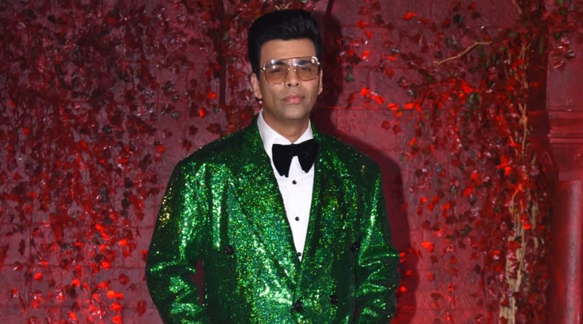 Karan Johar glitters in a green blingy jacket as he strikes pose for the paps at his 50th birthday bash