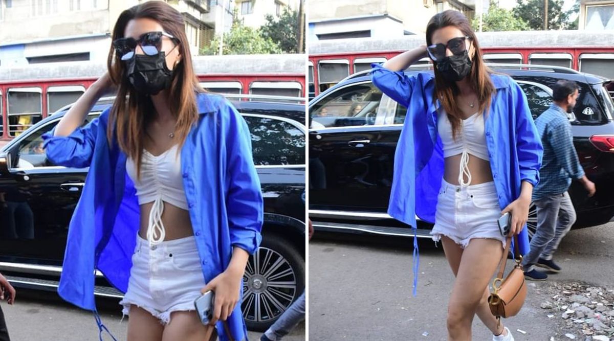 Kriti Sanon nails an off-duty look wearing white shorts, a crop top, and an oversized blue shirt